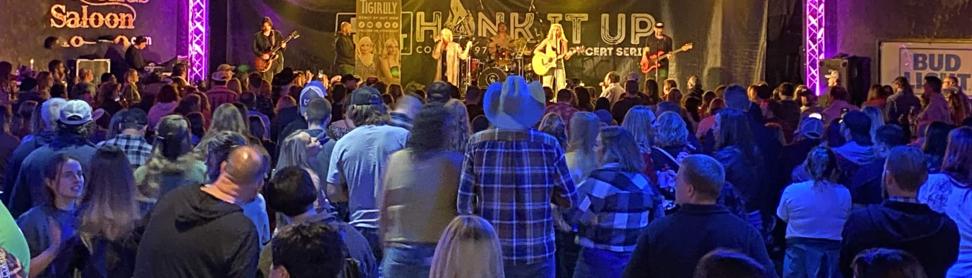 country concert with fans wearing cowboy hats Albuquerque