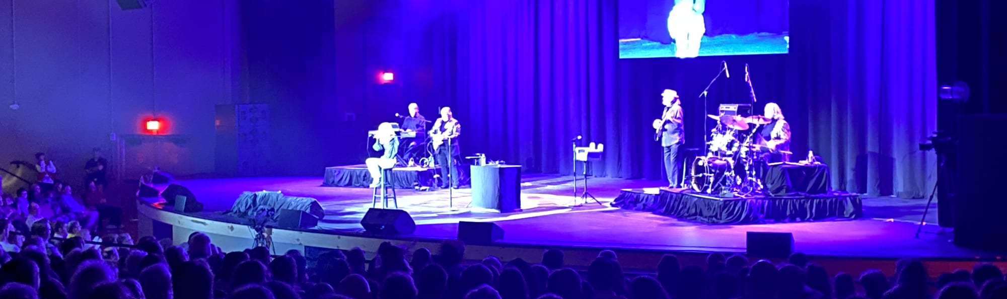 signer on stage in chair washed out by the lights Albuquerque